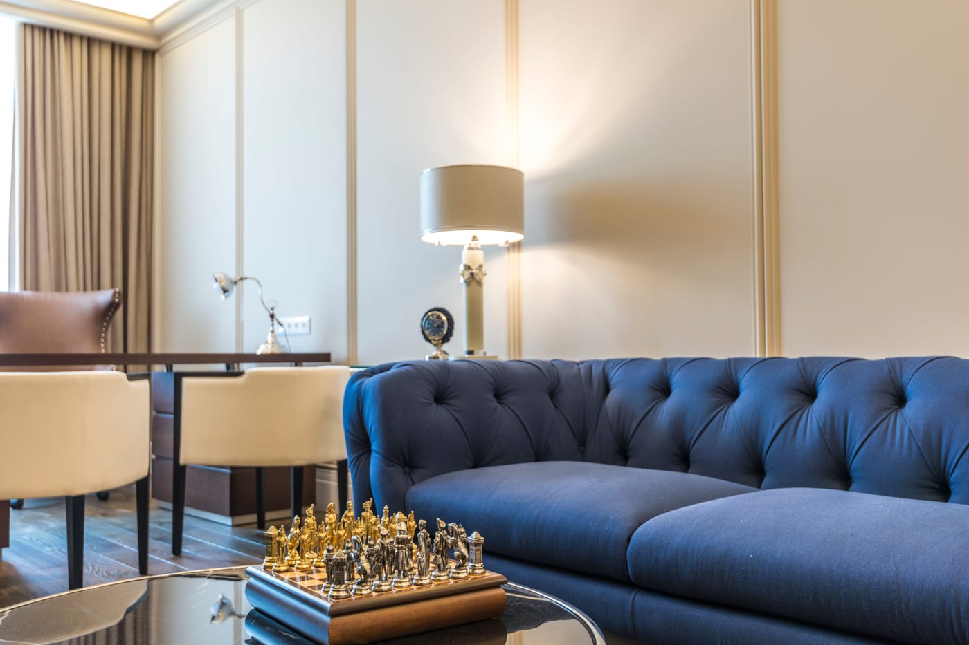 Living room with a range of upholstered furniture, including a tufted sofa and accent chairs, in a Capitola home